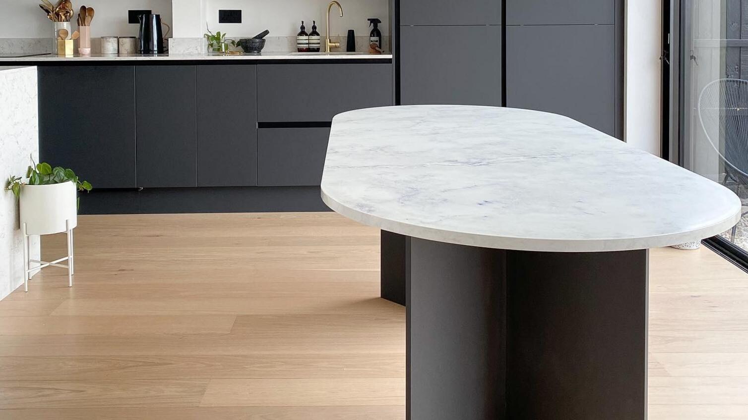 Black matt kitchen with engineered wood flooring
