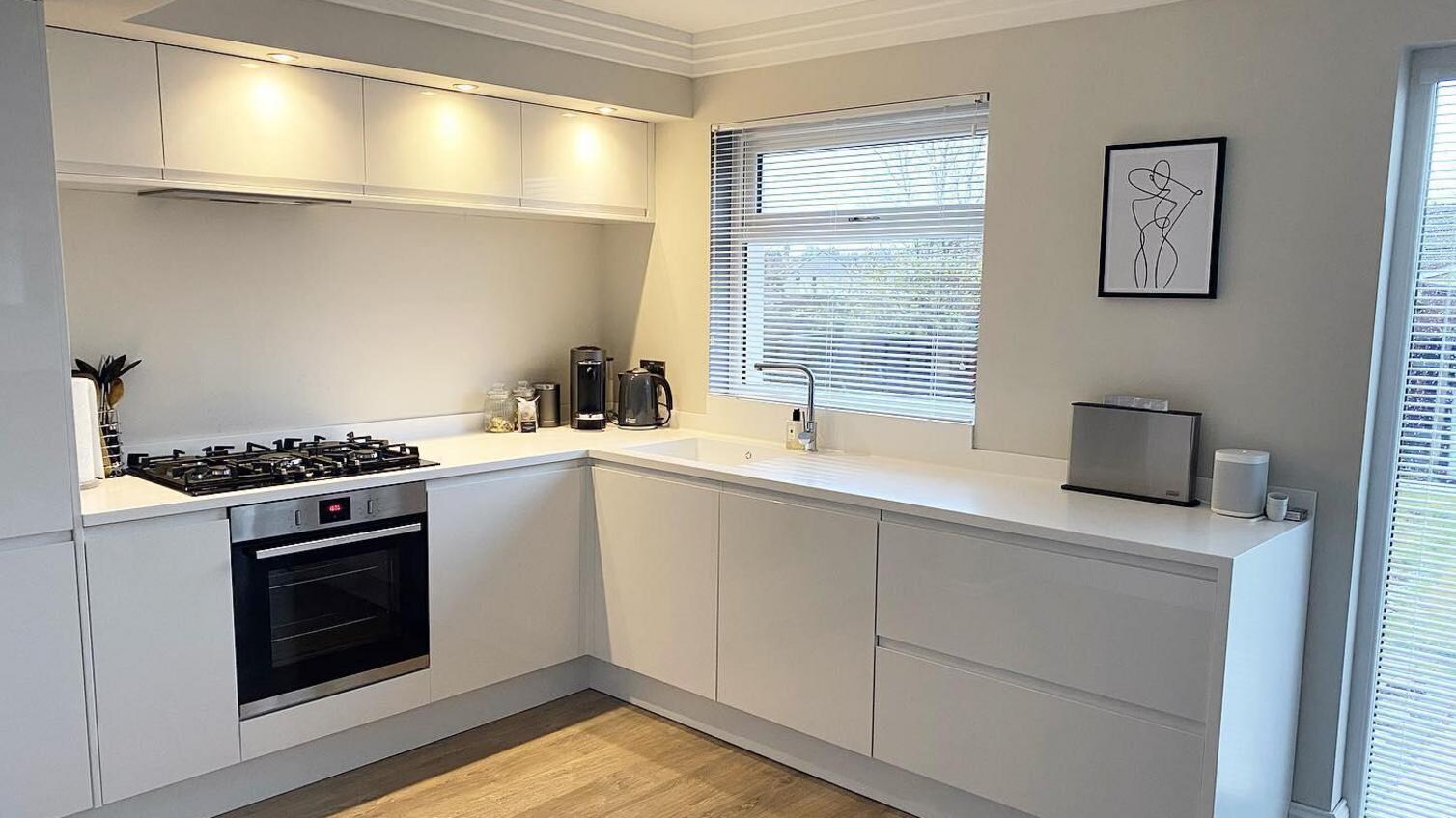 white integrated handle kitchen and warm white ceiling lights
