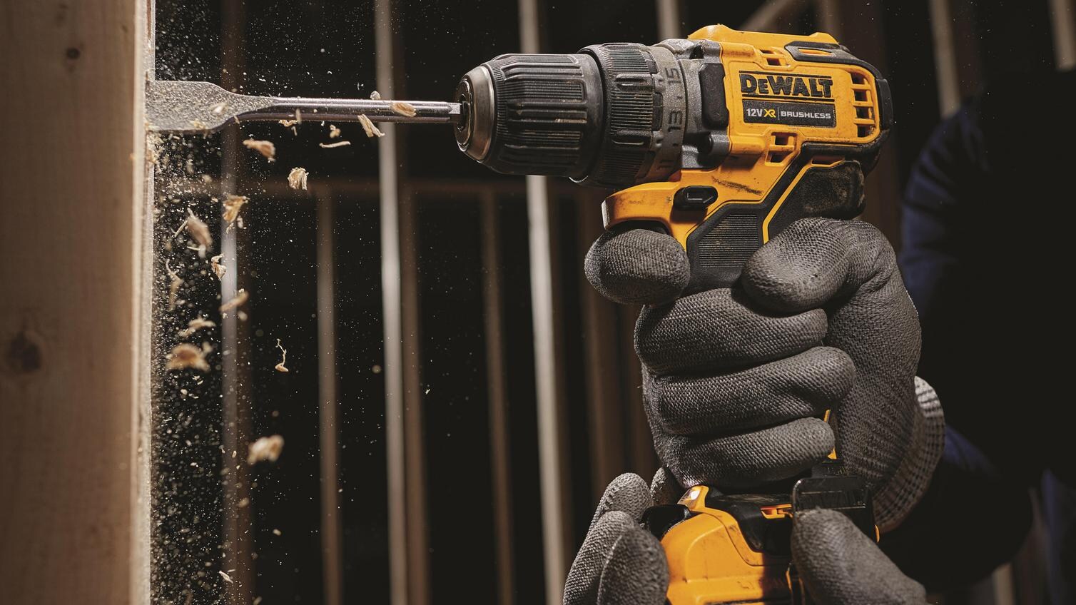 DeWalt DCD701D2 brushless driver being used by a trade professional into timber material.