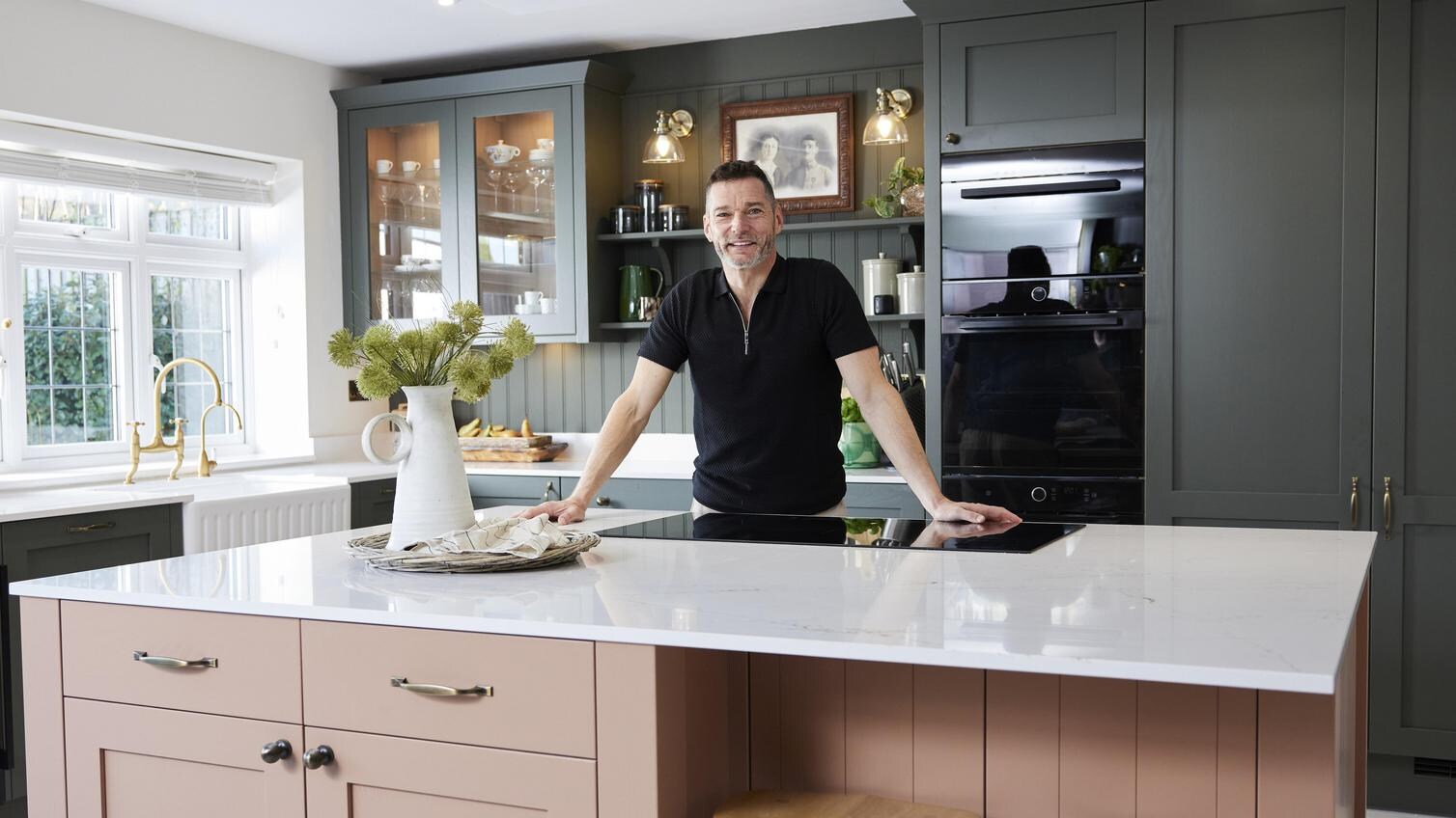 Fred stood in his kitchen, behind the counter.