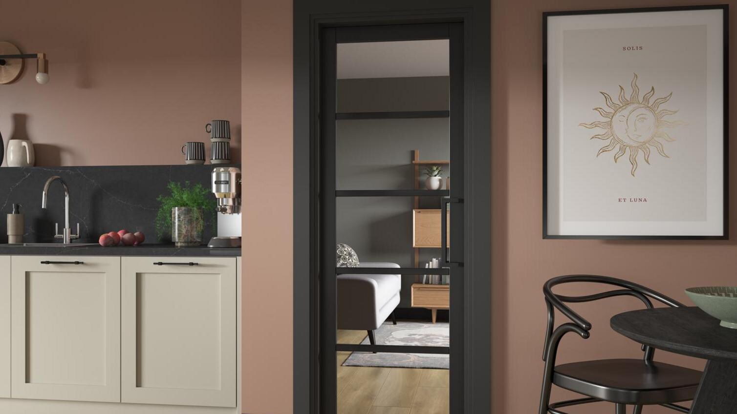 A black internal kitchen door with glazed panels, inside a modern  cooking space.