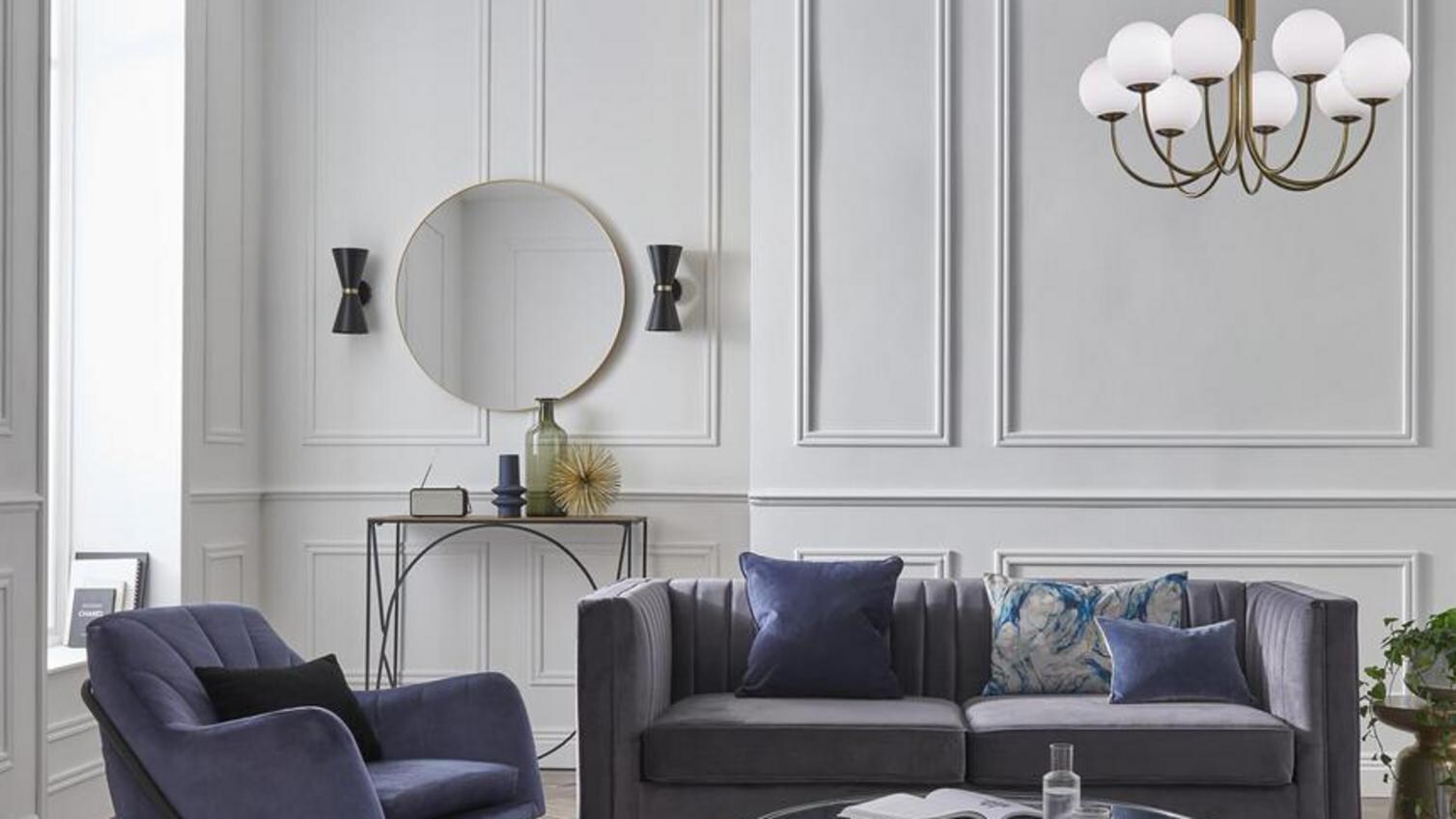 A white living room with decorative moulding used to create visual interest on plain white walls