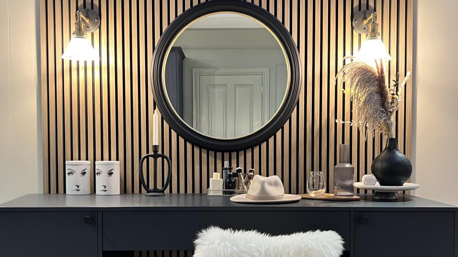 Acoustic wall panelling used in a bedroom to create a navy dressing and makeup area