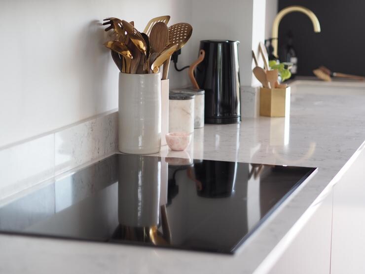 black induction hob on white marble worktop