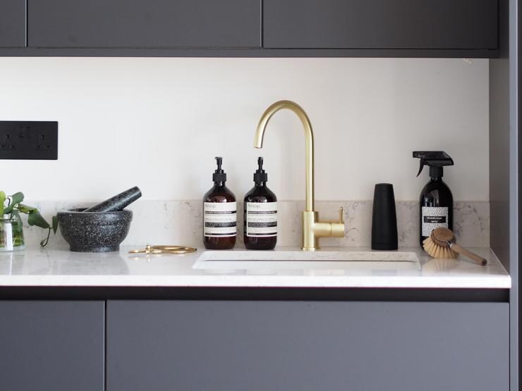 Undermount sink with brass tap and white workop