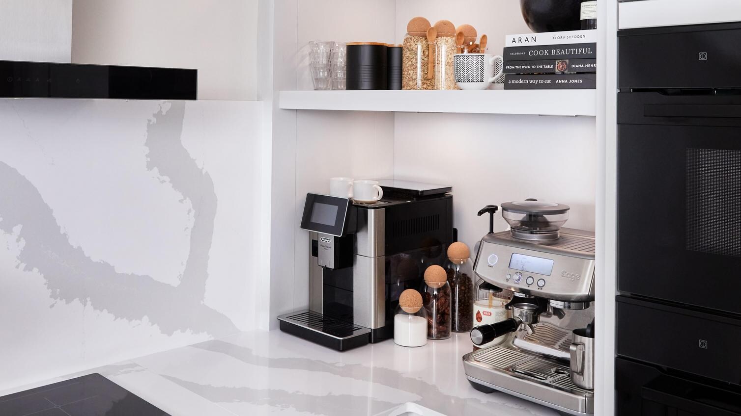A modern classic kitchen makeover with dove-grey shaker doors, black handles, white quartz worktops and bespoke shelving.