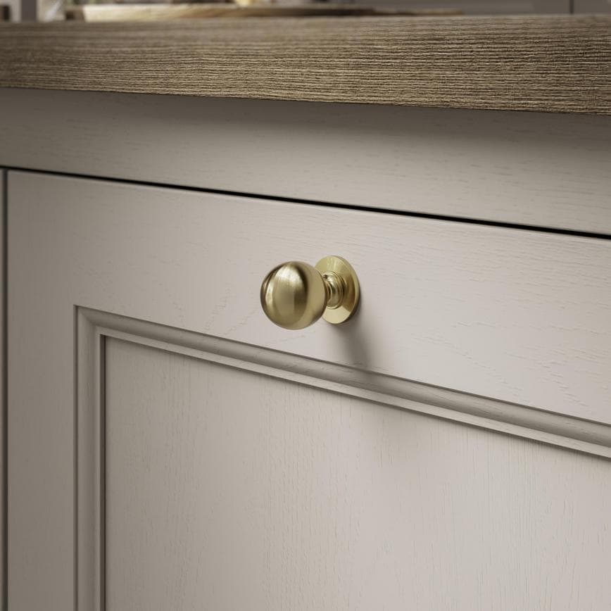 Beehive Satin Brass Smooth Cabinet Knob on Kitchen Door Close Up