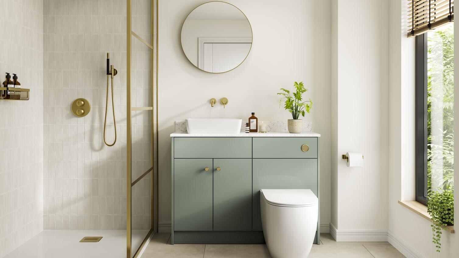 A reed green, slab kitchen in a single wall layout. There are white worktops, tile flooring, gold handles, and a white sink.