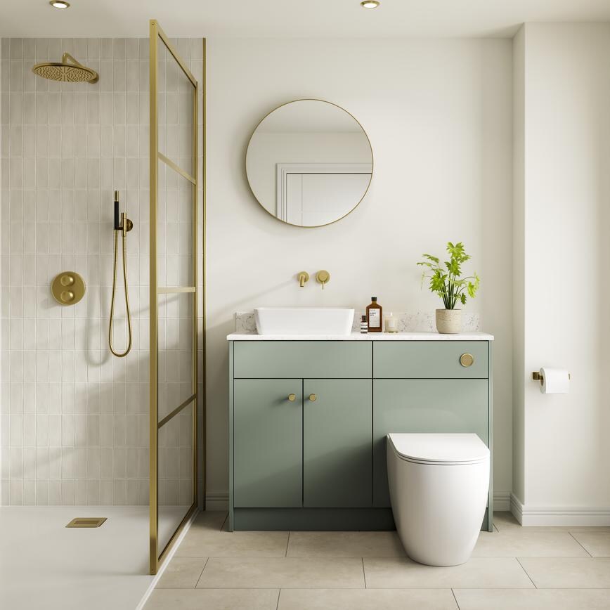 A reed green, slab kitchen in a single wall layout. There are white worktops, tile flooring, gold handles, and a white sink.