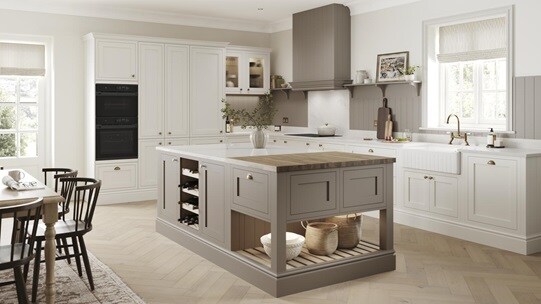 A mushroom brown shaker Ilfracombe kitchen island. It has matching base & tower units in porcelain, & oak-effect flooring. 