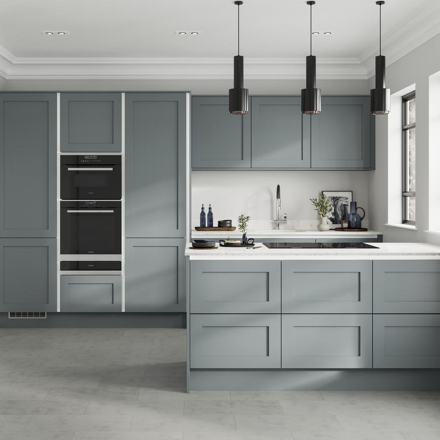 Handleless dusk-blue shaker kitchen with white trims in a peninsula layout. Contains double drawer units and grey floors.