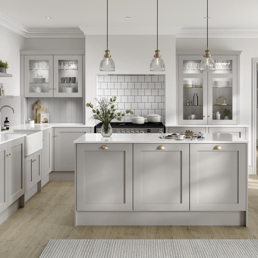 Country style dove grey shaker kitchen in kitchen island layout. Recessed oven area with square white brick tiles.