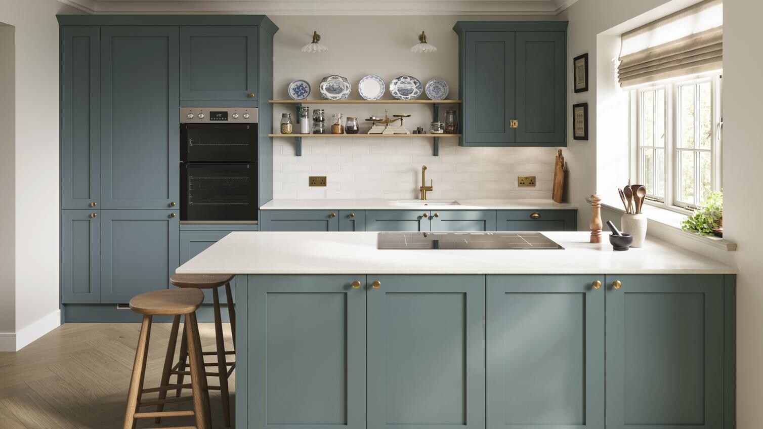 A blue peninsula kitchen with shaker door fronts. The kitchen has marble-effect worktops, breakfast bar, and brass handles.