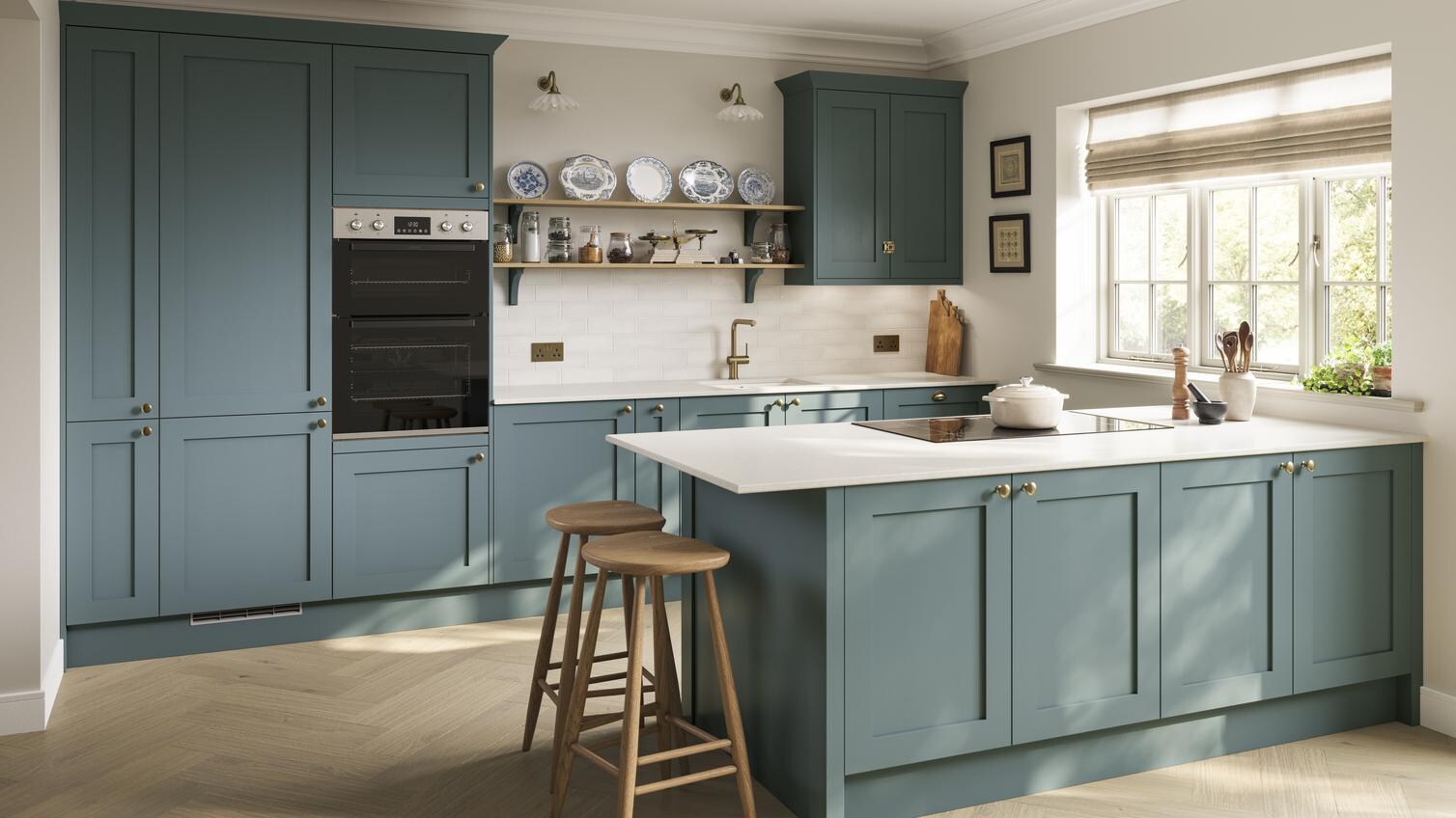 A blue peninsula kitchen with shaker door fronts. The kitchen has marble-effect worktops, breakfast bar, and brass handles.