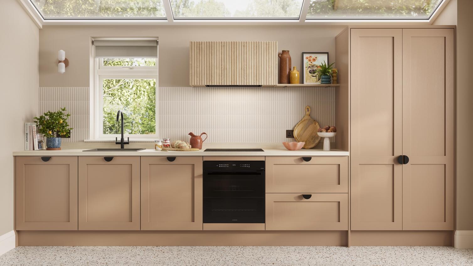 A shaker terracotta kitchen from the Chilcomb collection. It is in a single-wall layout and has rounded black handles.