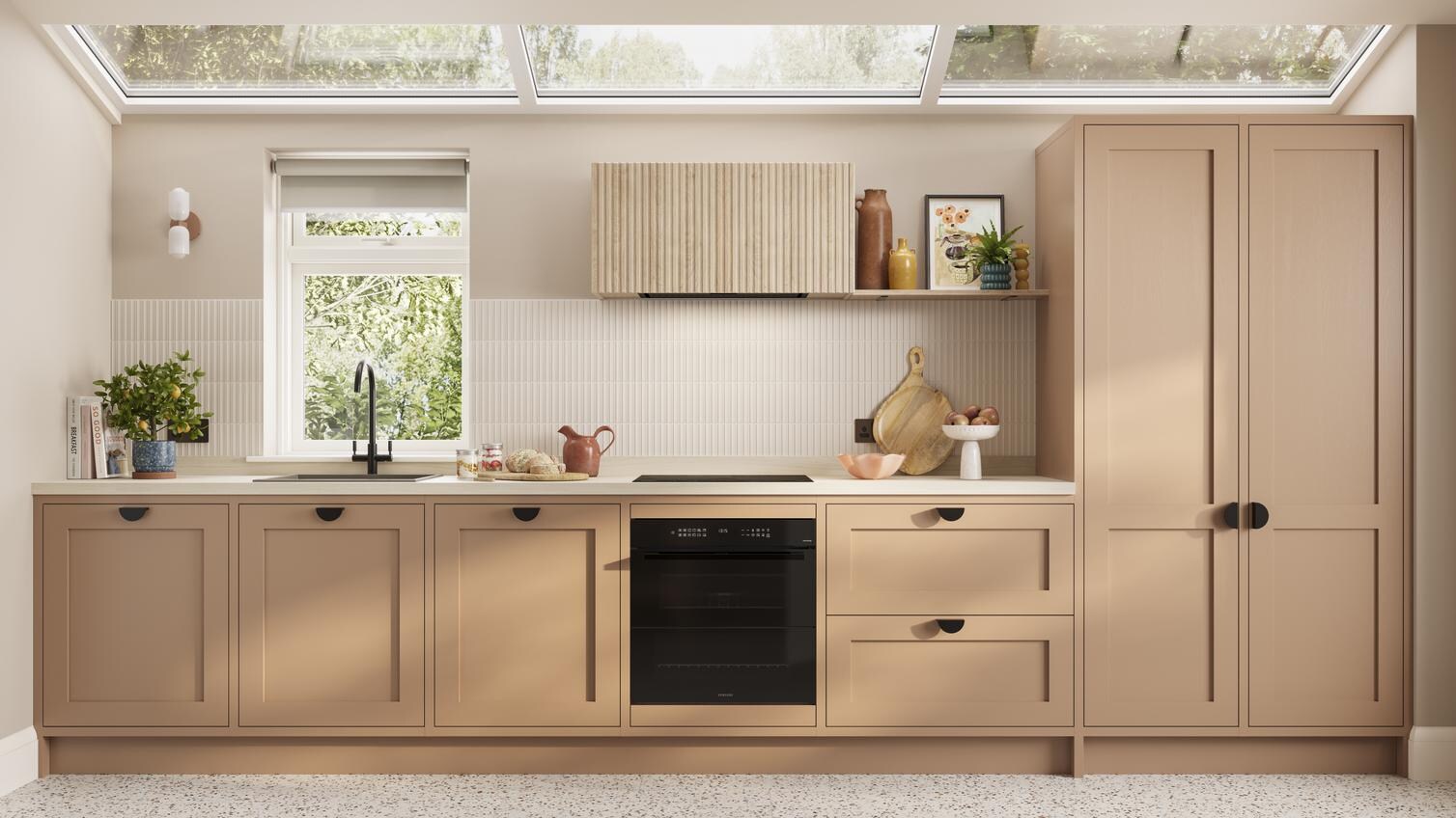 A single wall kitchen featuring teracotta shaker doors. Styled with black handles, a white worktop, and built-under oven.
