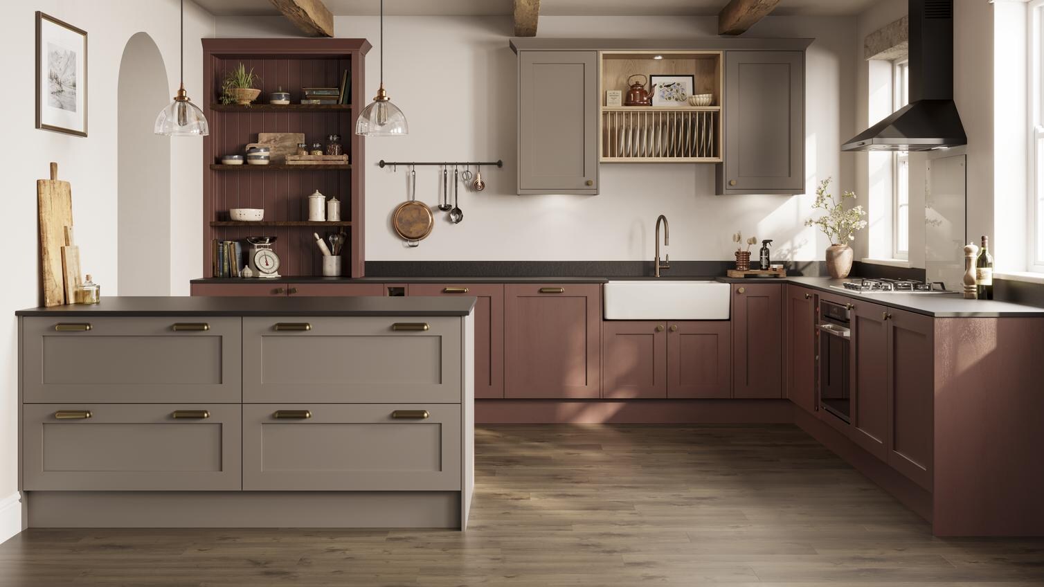 An earth red shaker kitchen in a peninsula layout. It is finished with black stone work and oak-effect panel flooring. 