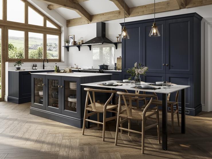 Navy shaker doors with a beaded detail in an island layout. Includes a black extractor, white worktops, and tower units.