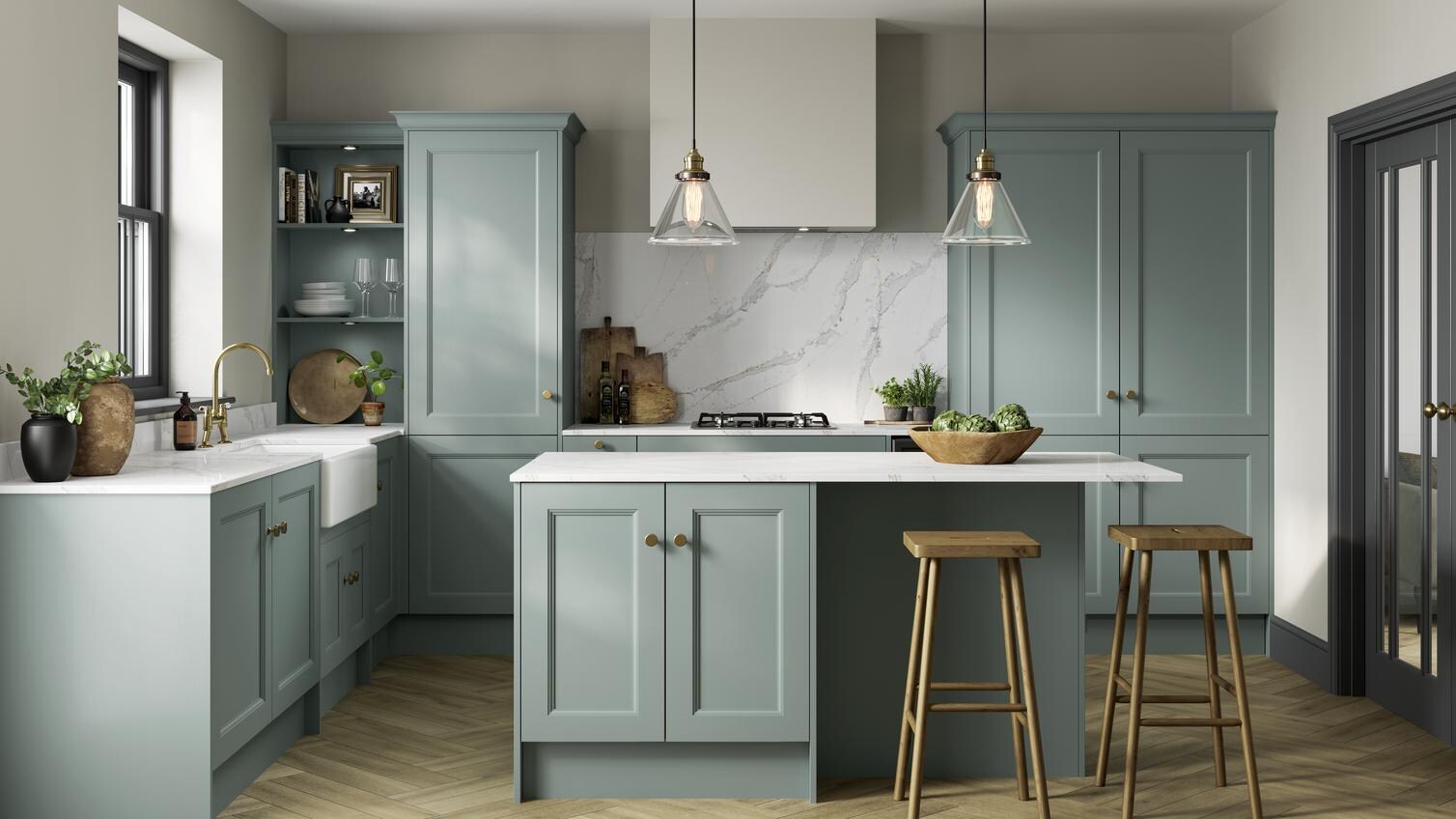 An l-shaped shaker kitchen, with a seafoam blue finish. It has a kitchen island, brass accessories, and oak-style flooring.