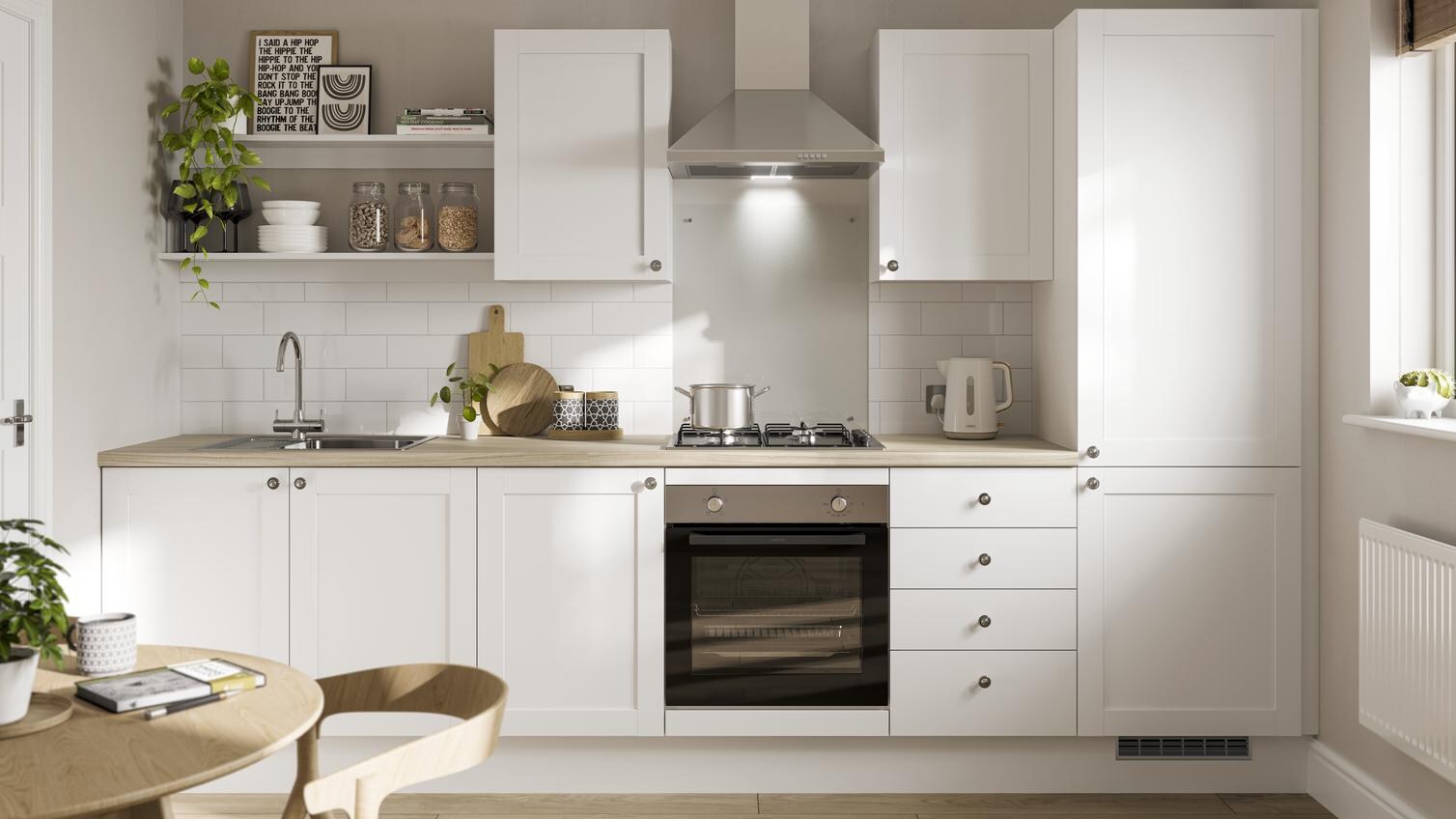 A white shaker kitchen design with classic features including an oak worktop and flooring, chrome handles and a chrome sink.