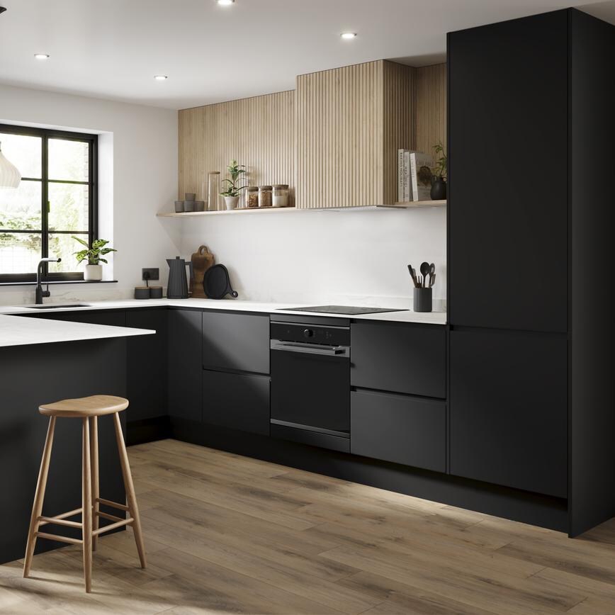 A black kitchen in a U-shaped layout with integrated handle cupboards. Includes white, marble-effect worktops and oak floors.