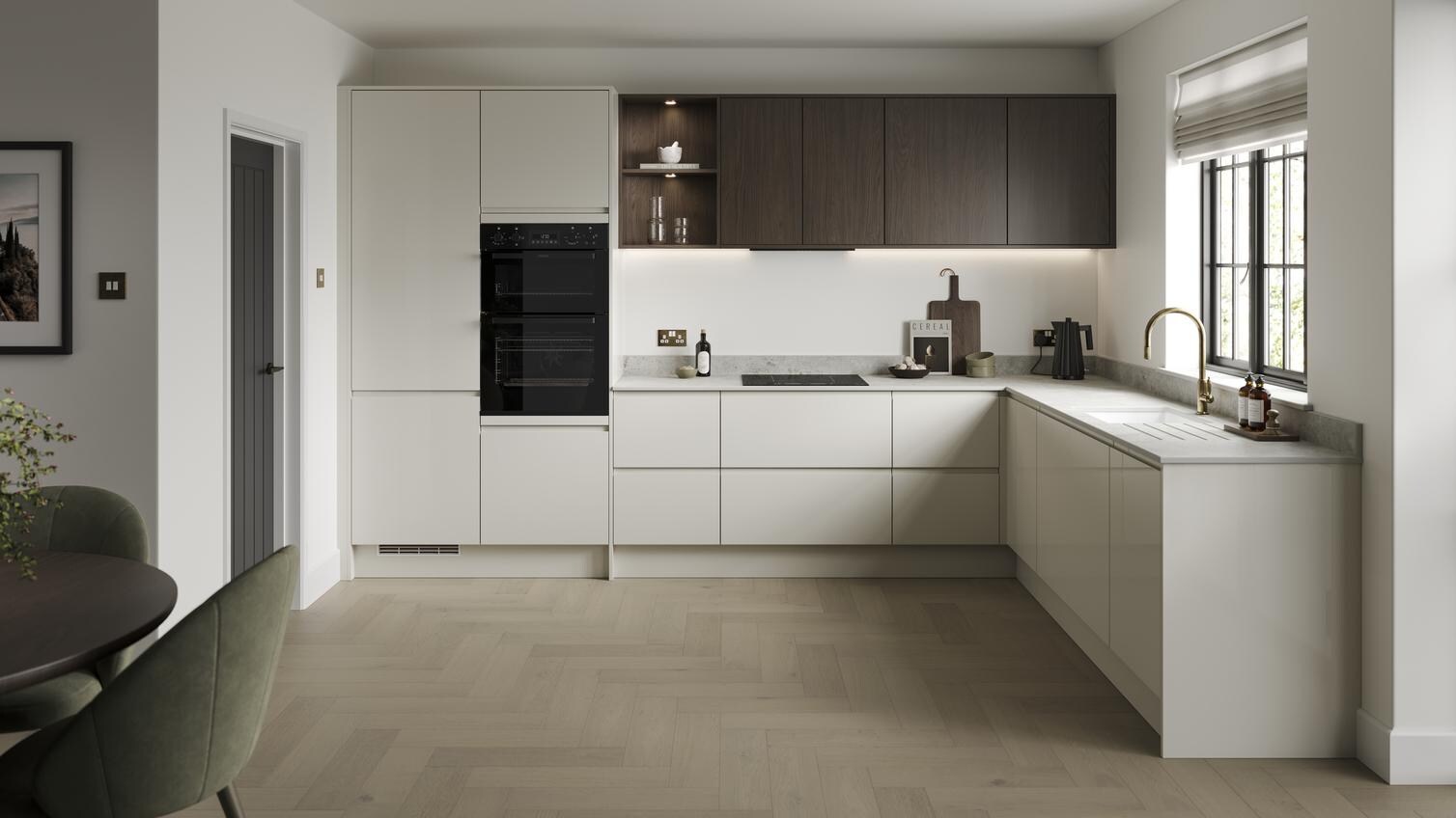 An l-shaped kitchen layout in a white porcelain colour. It has light oak herringbone flooring an integrated appliances.