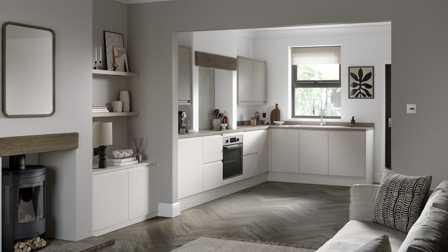Open-plan kitchen and living room from Clerkenwell Super Matt Porcelain. It has oak herringbone flooring and stone worktops. 