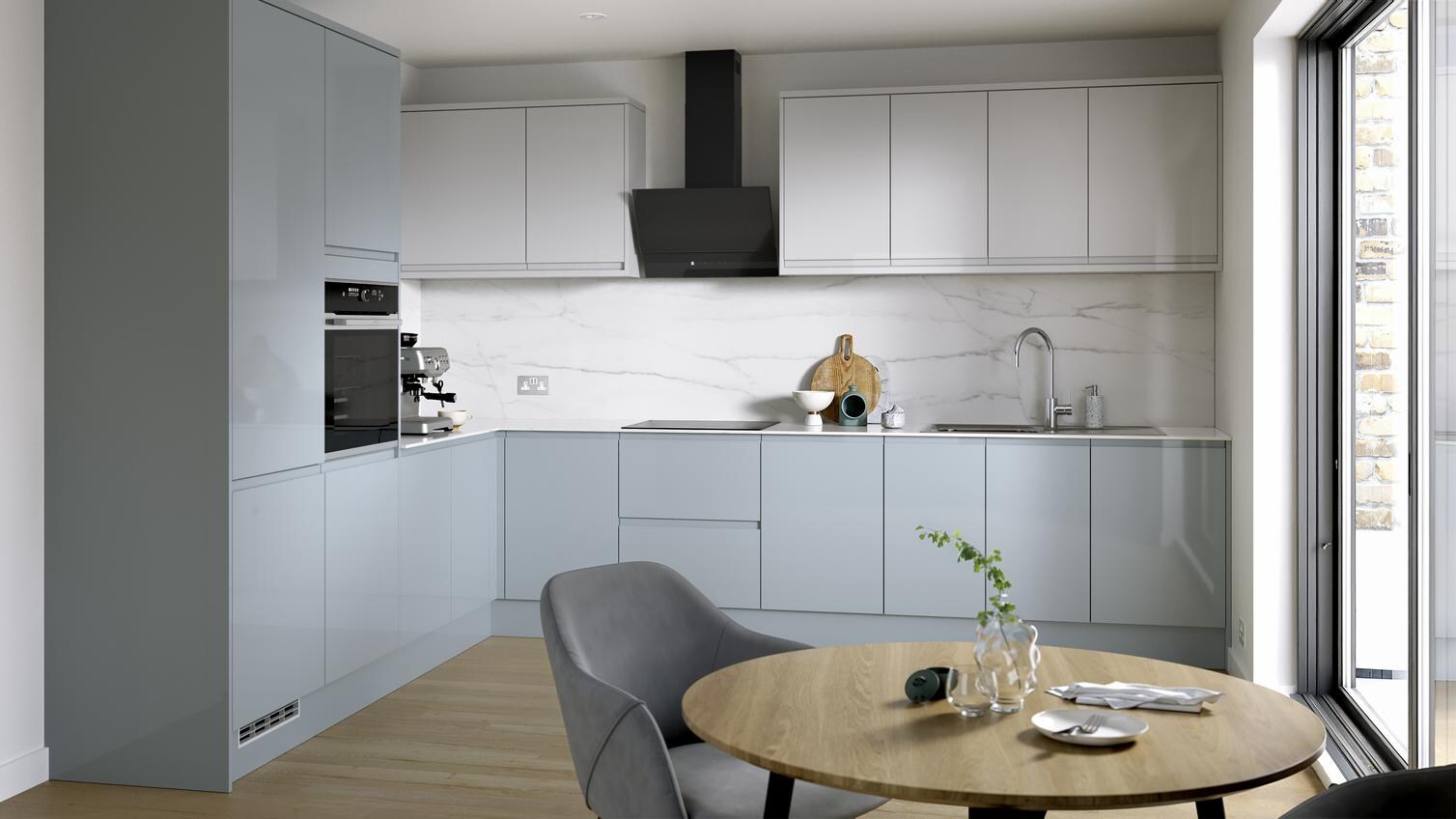 A blue kitchen from  Clerkenwell Mist, in an l-shaped layout. It has a gloss finish, white wall cabinets & marble backboard.