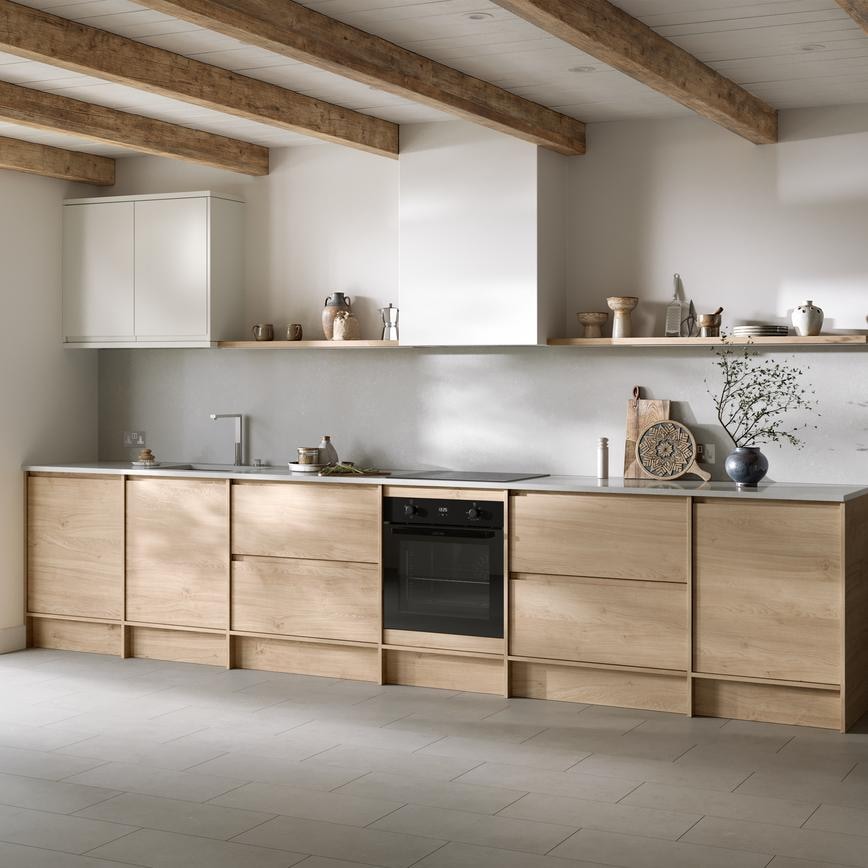 Natural oak kitchen from the Clerkenwell collection. It is in a single-wall layout with tiled flooring & white wall cabinets.