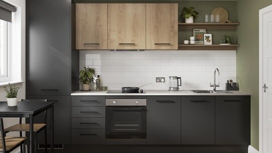 A contemporary black kitchen with matching black handles, oak-effect wall cabinet, and white counter in a single-wall layout