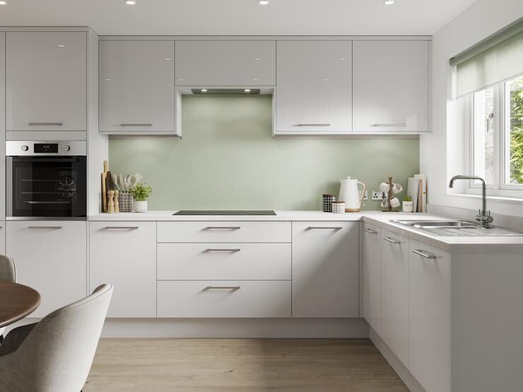 A dove grey kitchen in a gloss finish and in an L-shaped layout. It has integrated appliances and light-oak flooring.