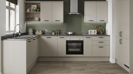 A sandstone kitchen design with gloss slab doors, chrome bar handles, a laminate stone-effect work surface, and chrome tap