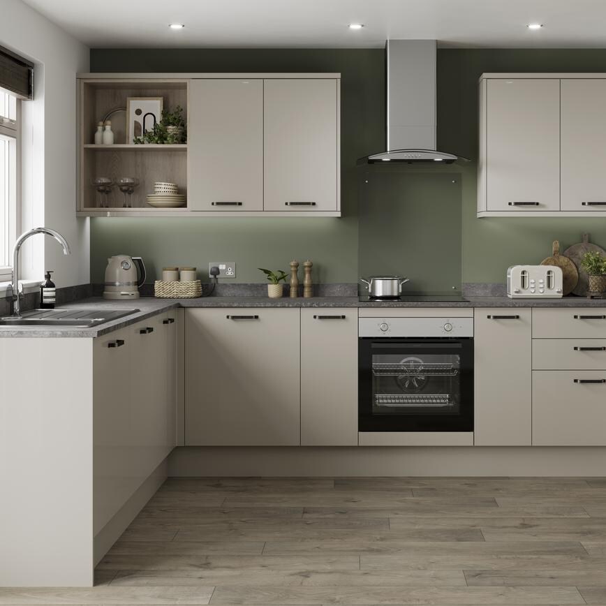 A sandstone kitchen design with gloss slab doors, chrome bar handles, a laminate stone-effect work surface, and chrome tap