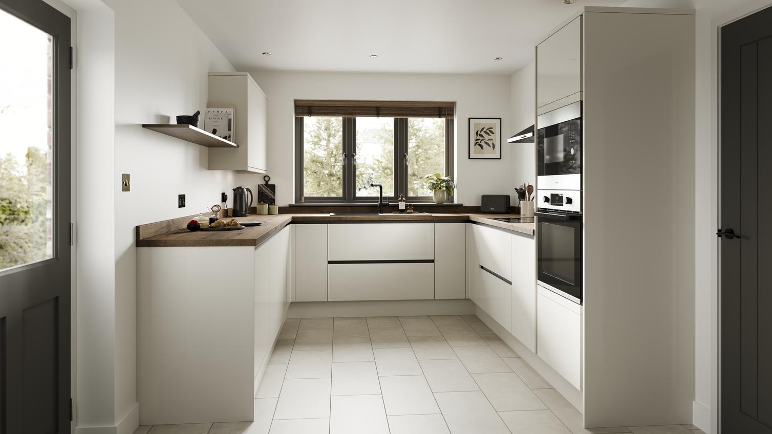 A porcelain, slab kitchen in a gloss finish and u-shaped layout. It has dark worktops, handleless doors and black profiles. 