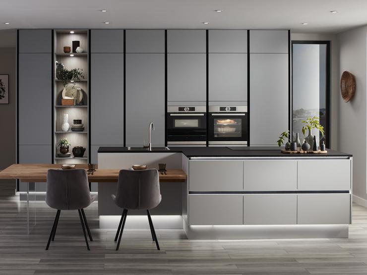 Super matt slate grey handleless kitchen with p shaped kitchen island unit, black kitchen worktop and integrated black trims.