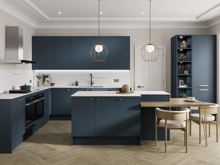 Marine blue kitchen idea with slab doors in an island layout. Has white worktops, light chevron floors, and knob handles.