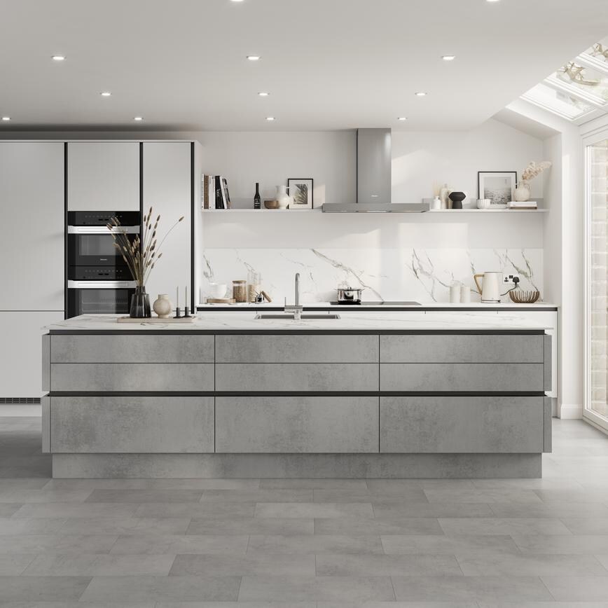 Open-plan kitchen with island and handleless concrete-effect doors. Contains matt-black metal trims for an industrious look.