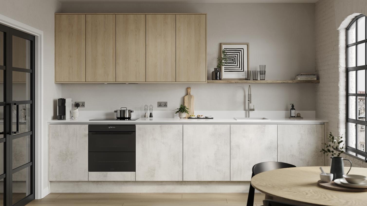 A slab kitchen island layout in a textured white stone finish. It also has grey cabinets on one wall & marble-style surfaces.