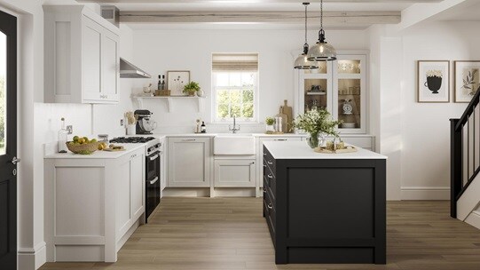 A Halesworth shaker-style kitchen in a light, dove grey finish. The kitchen white worktops, and a dark-coloured kitchen island