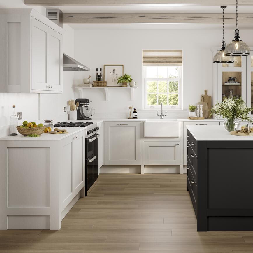 A Halesworth shaker-style kitchen in a light, dove grey finish. The kitchen white worktops, and a dark-coloured kitchen island