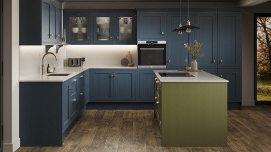 A marine blue shaker kitchen from Ilfracombe, in an l-shaped layout. It has an olive-colour island and oak plank flooring.