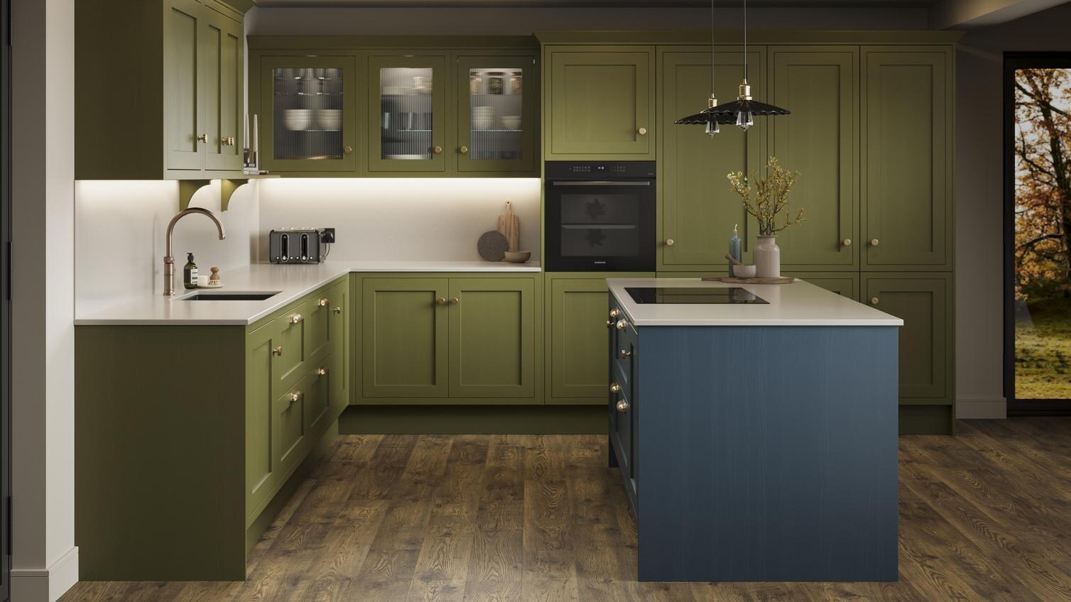 An olive shaker kitchen from Ilfracombe, in an l-shaped layout and a marine blue island. It also has dark oak flooring. 