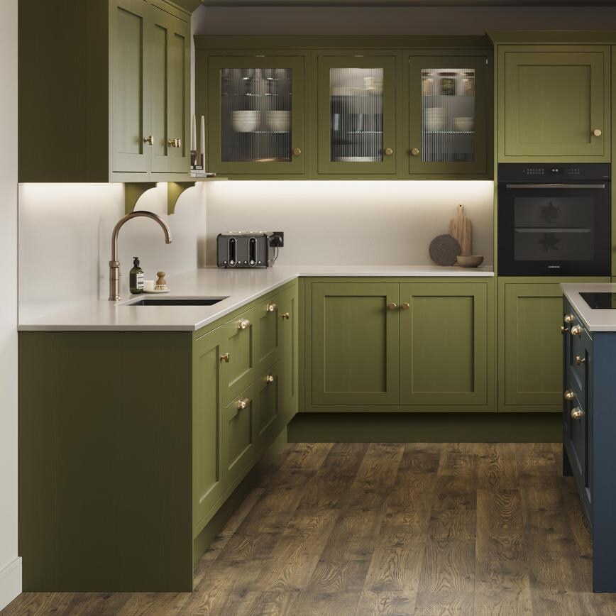 An olive shaker kitchen from Ilfracombe, in an l-shaped layout and a marine blue island. It also has dark oak flooring. 