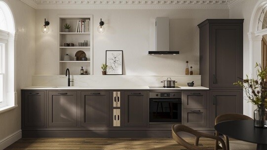 A brown shaker kitchen from Ilfracombe Truffle, in a single wall layout. It has black accessories and dark oak flooring.