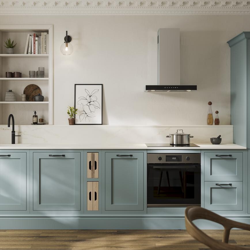 A blue shaker kitchen from Ilfracombe Seafoam, in a single wall layout. It has a black tap, accessories, and oak flooring. 