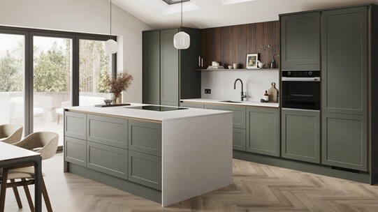 An ash green, shaker kitchen island in a matt finish & handleless style. It has quartz worktops with side panels & backboard