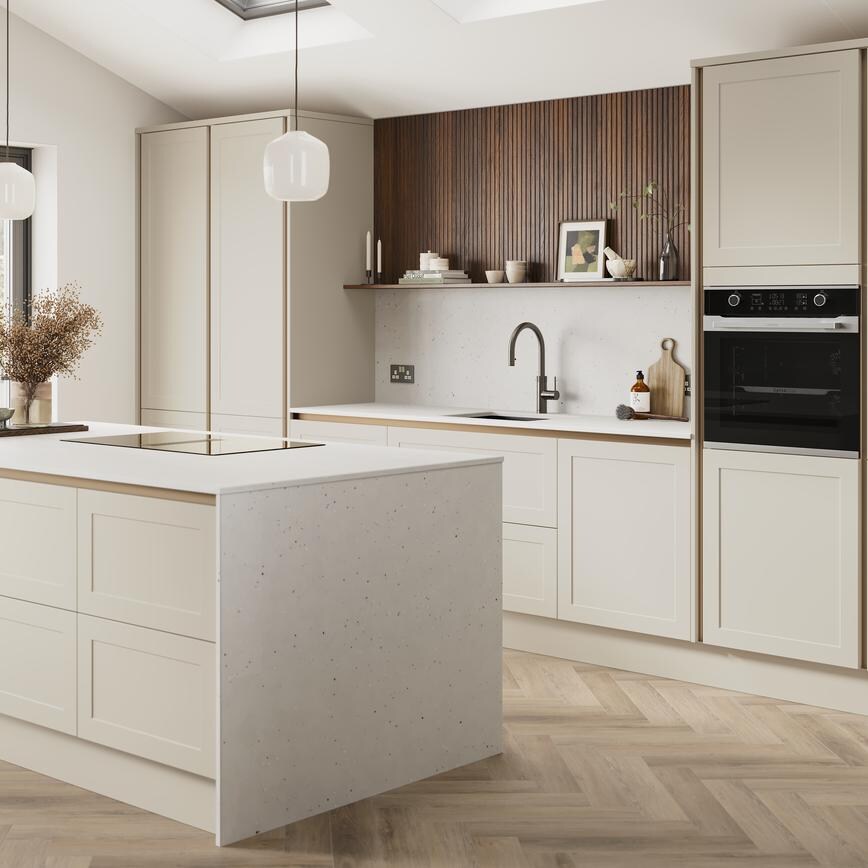 A porcelain, handleless kitchen island in a matt finish & shaker style. It has quartz worktops with side panels & backboard. 