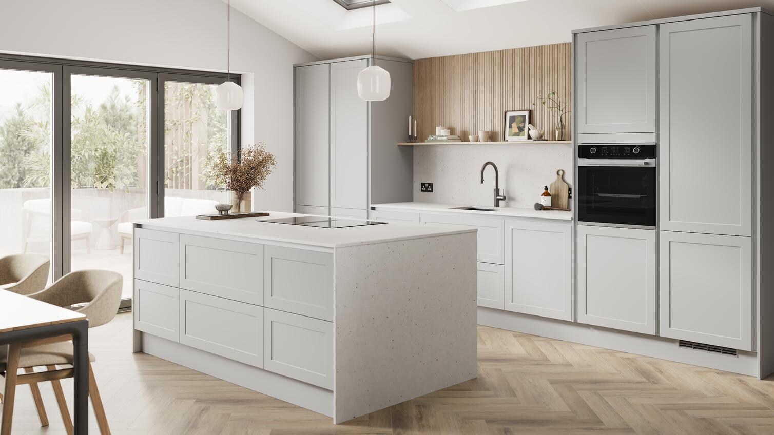 A dove grey, shaker kitchen island in a matt finish & handleless style. It has quartz worktops with side panels & backboard. 
