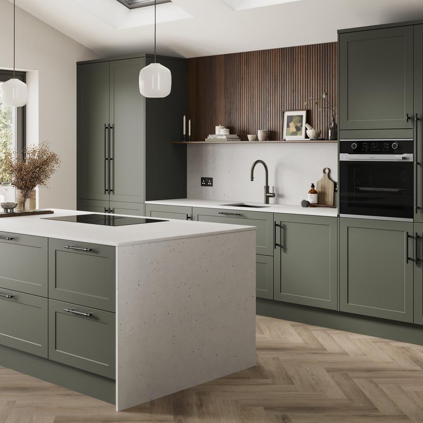 An ash green, shaker kitchen island layout in a matt finish. It has quartz worktops with matching side panels and backboard. 