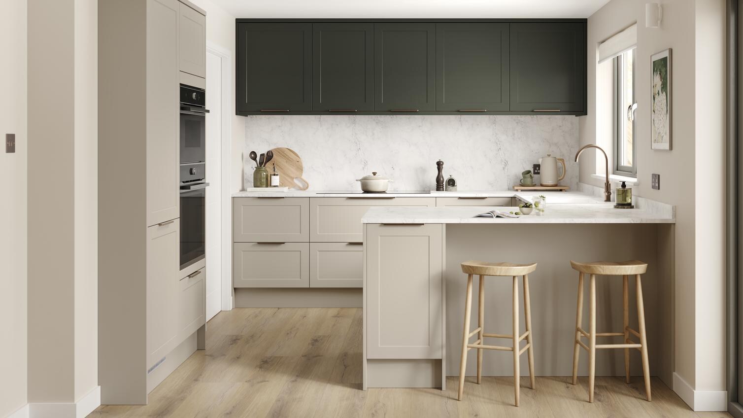 A shaker, sandstone kitchen in a peninsula layout from the Frome range. It has oak plank flooring and green wall cabinets. 